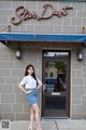 A woman standing in front of a star dust restaurant.