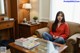 A woman sitting on a couch in a living room.