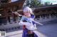 A woman in a blue and white outfit holding a sword.