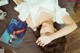 A woman laying on a bed next to a magazine.