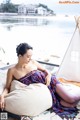 A woman sitting on a bean bag chair next to a teepee.