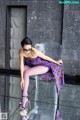 A woman sitting on top of a clear chair.