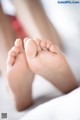 A close up of a baby's feet on a bed.